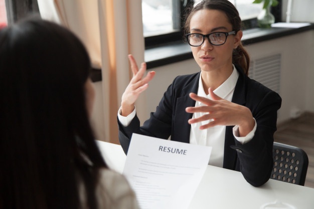 confident-millennial-female-applicant-glasses-talking-job-interview_1163-4683